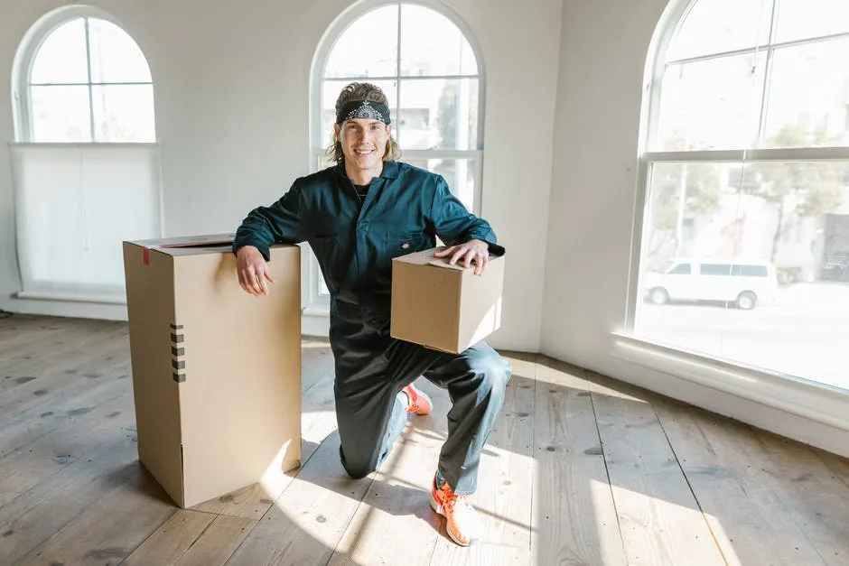 Happy expat unpacking boxes in his new home