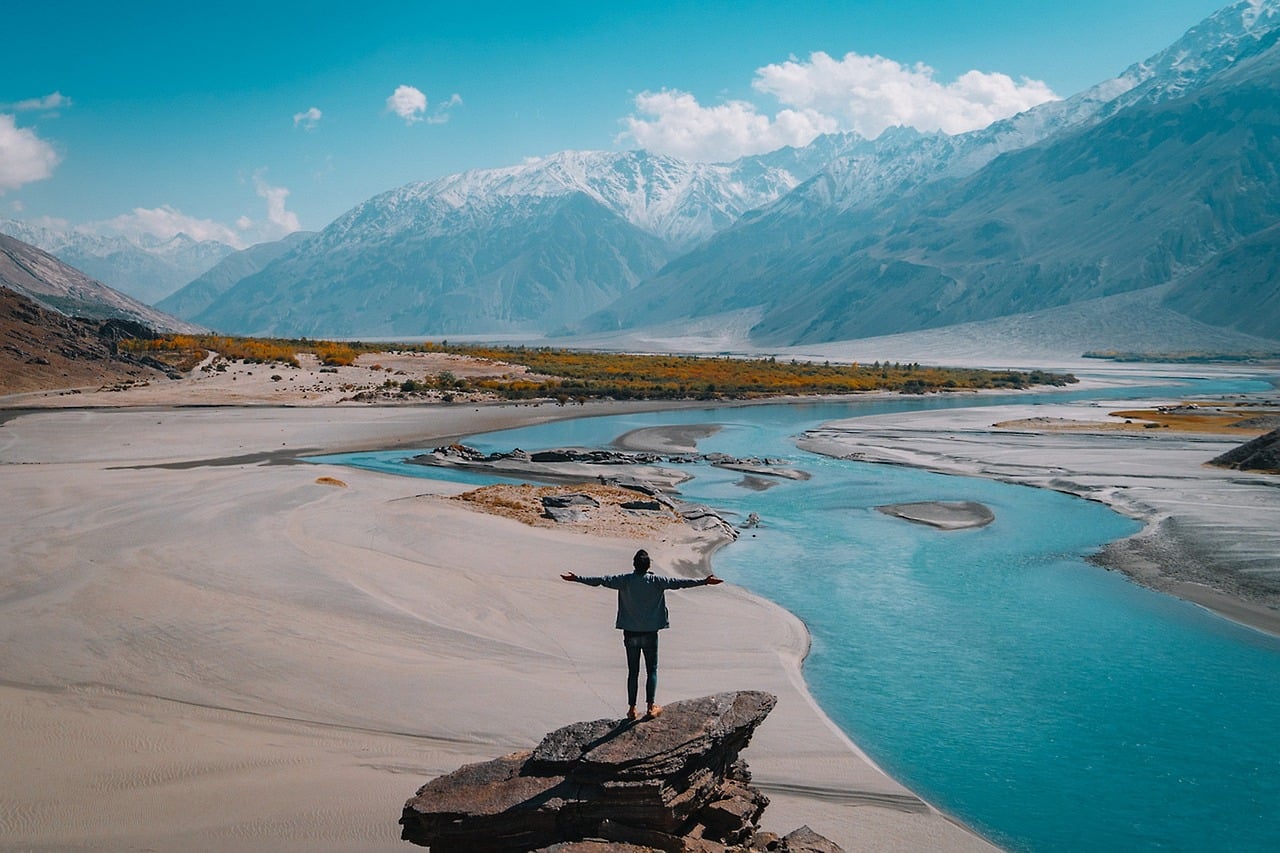 man standing looking at landscape