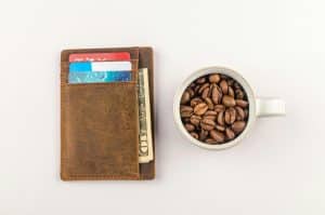 Wallet with credit cards and a mug with coffee beans inside