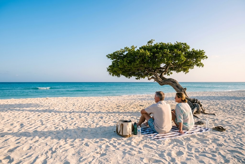 A traveler relaxing under a wind-bent divi-divi tree on Eagle Beach, Aruba